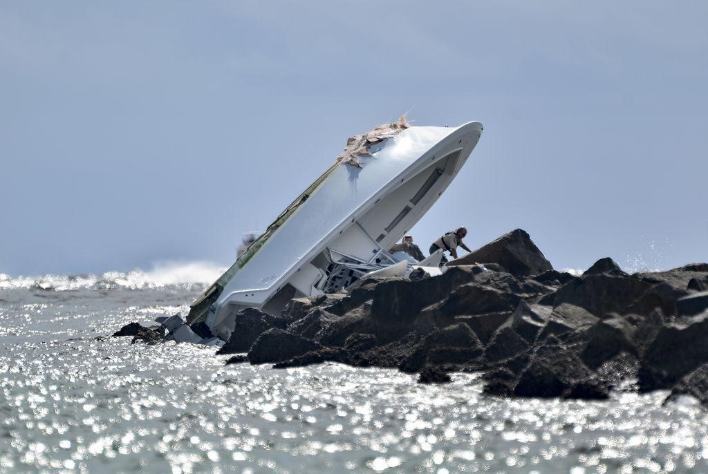 Image of boat on top of rocks at jetty
